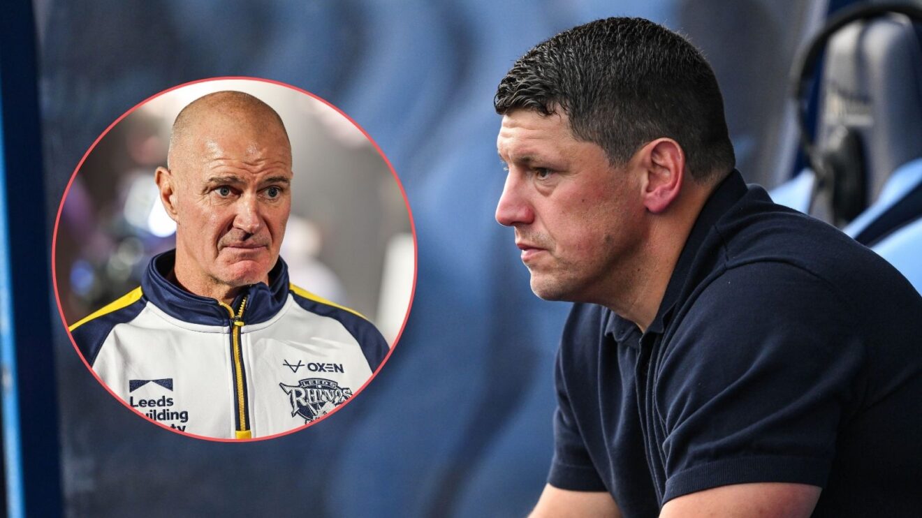 Wigan Warriors head coach Matt Peet sits in a dugout looking left towards a circle containing an image of Leeds Rhinos boss Brad Arthur