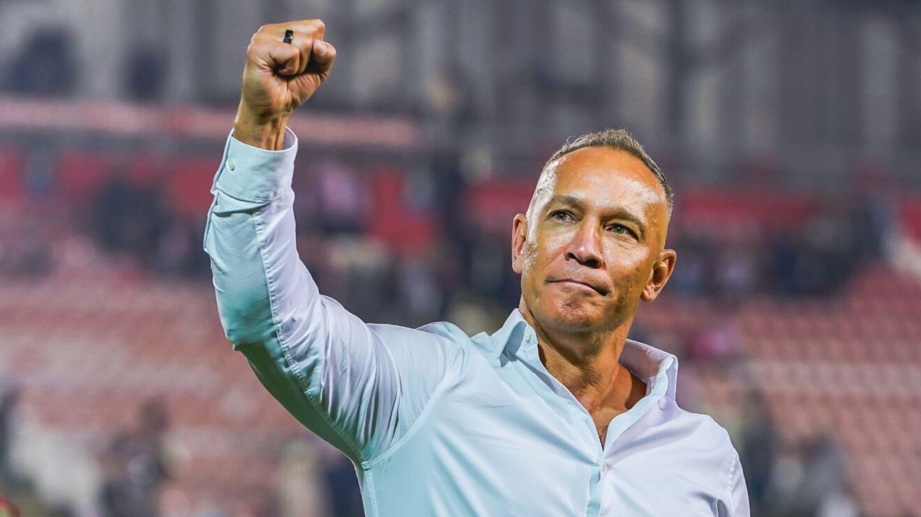 Leigh head coach Adrian Lam celebrates the Leopards' win over Wakefield Trinity in the play-off eliminators in September 2025 with a fist pump to the home crowd