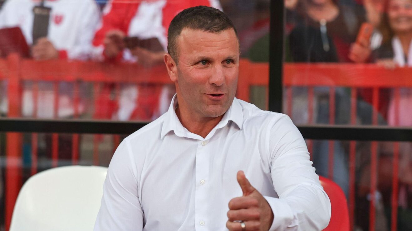 Hull KR head coach all smiles sat in the dugout at Craven Park ahead of a game in 2025