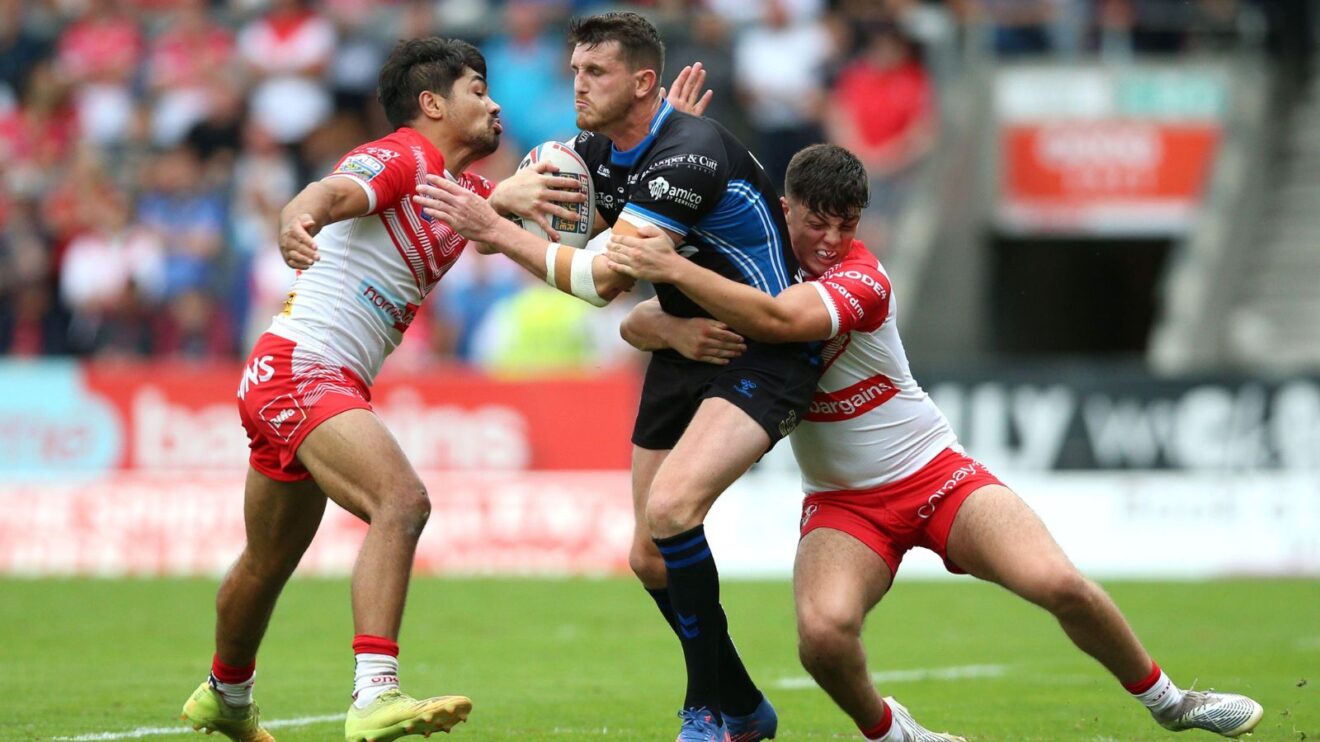 St Helens duo James Bell and Ellis Archer tackle Wakefield Trinity's Lee Gaskell during a Super League game in 2022