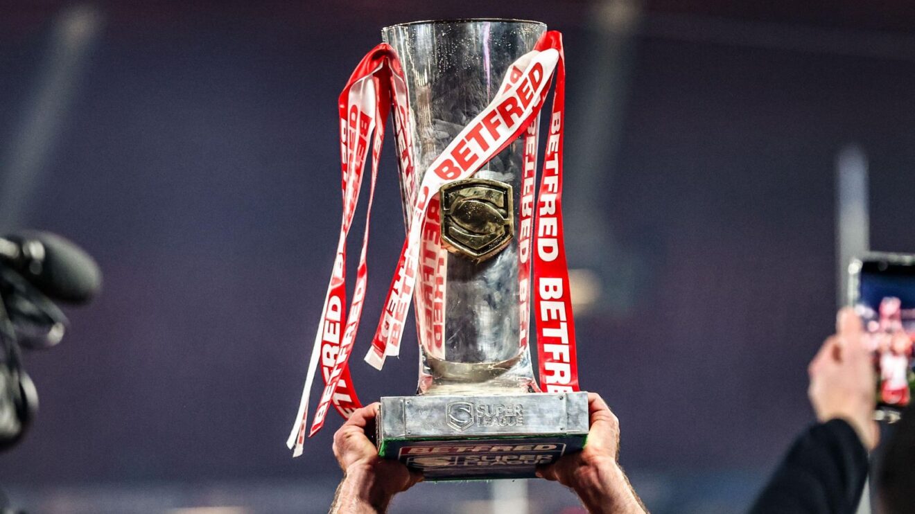 The Super League trophy being held aloft by an out of shot Hull KR player following their maiden Grand Final triumph in 2025