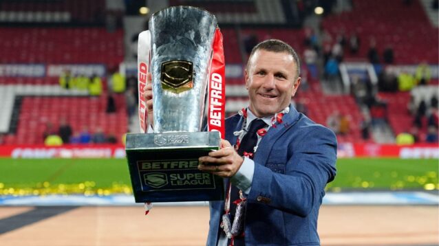Hull KR head coach Willie Peters holds the Super League trophy aloft after their 2025 Grand Final triumph