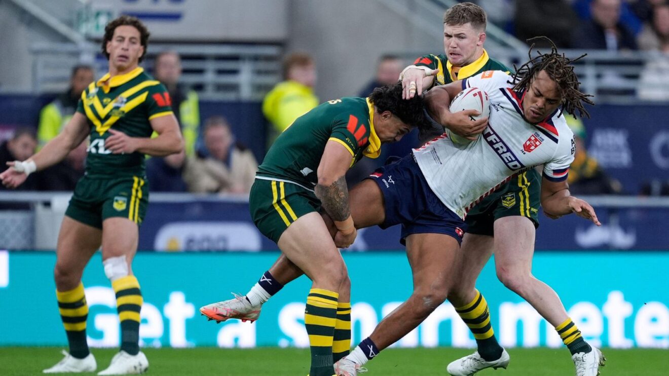 Dom Young in action for England against Australia in the second Test of the 2025 Ashes Series at Everton, being tackled by numerous Kangaroos players