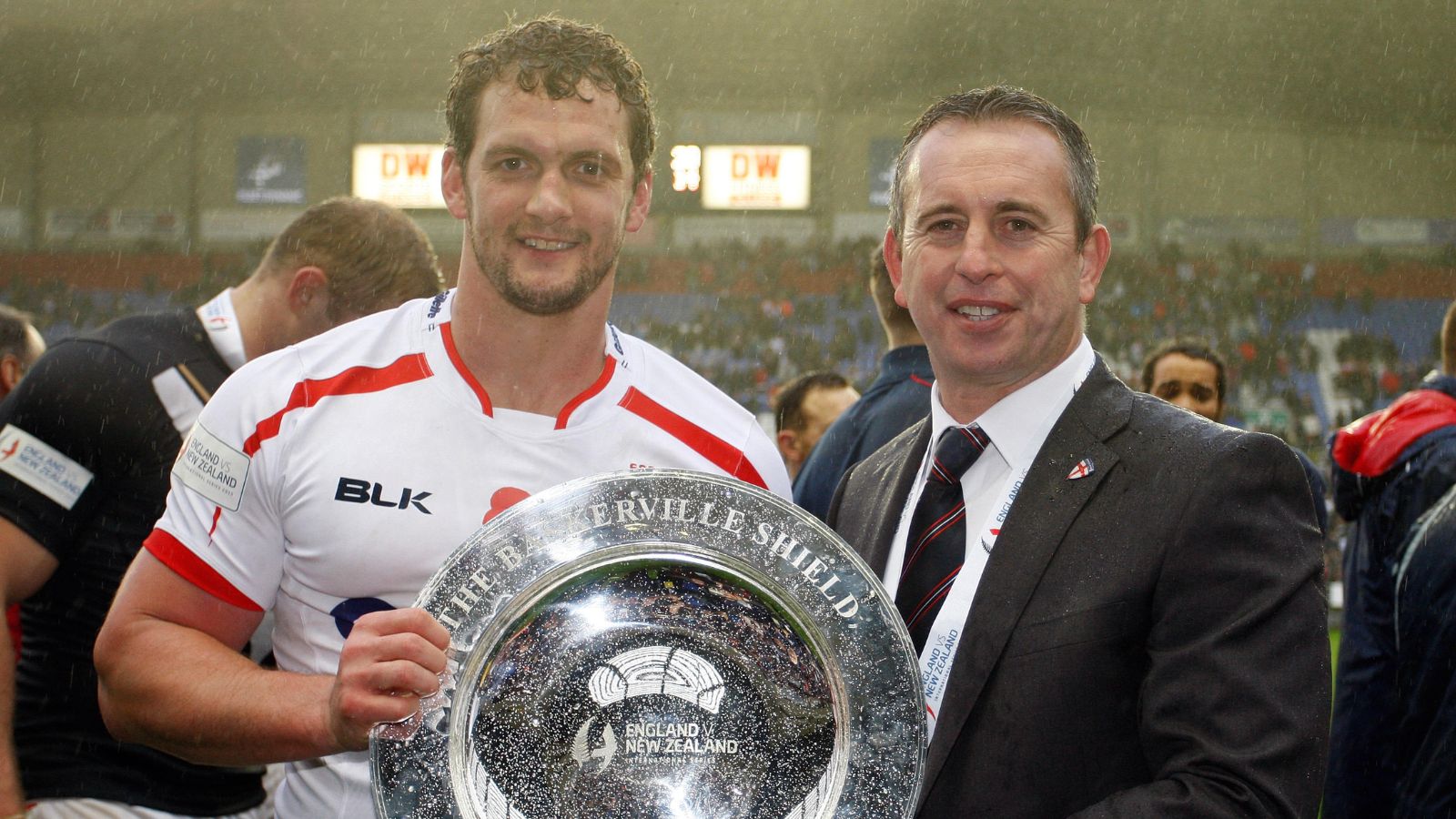 Sean O'Loughlin and then-England head coach Steve McNamara lift the Baskerville Shield following the series victory over New Zealand in 2015