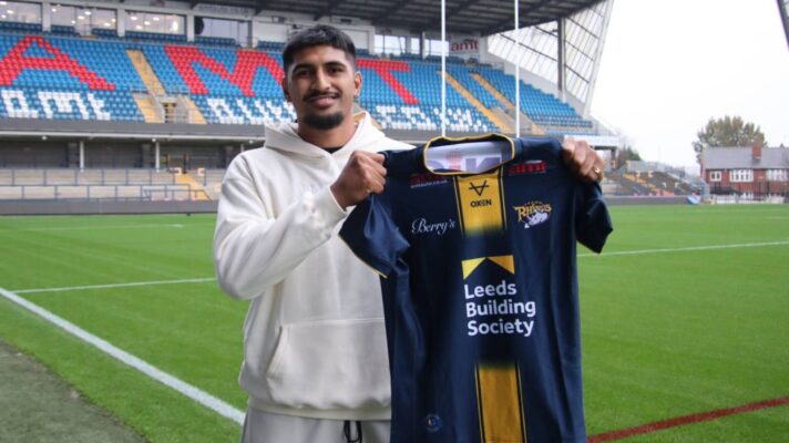 Jeremiah Mata'utia poses with a Leeds shirt at Headingley after signing for the Rhinos
