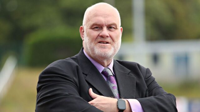 Nigel Wood pictured at a rugby league game in 2025, stood looking at the camera with his arms folded