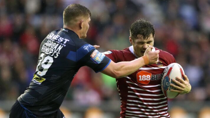 Leeds Rhinos' Josh Jordan-Roberts tackles Wigan Warriors' John Bateman during a Super League clash in 2017