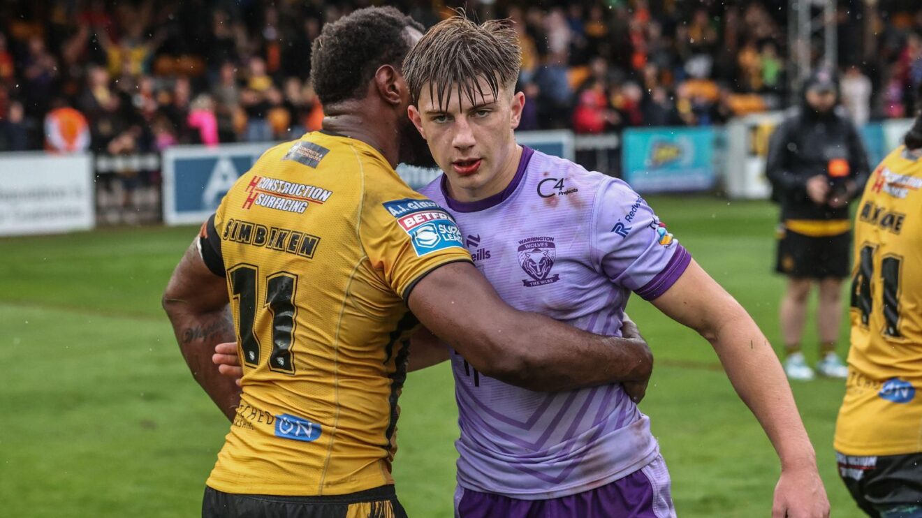 Warrington Wolves' Ewan Irwin embraces Castleford Tigers' Jeremiah Simbiken following a Super League clash in 2025