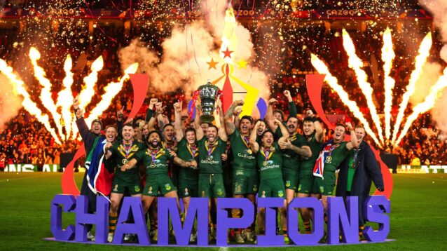 Australia lift the World Cup at Old Trafford in 2022 with fireworks let off behind them and a 'CHAMPIONS' sign in front of them