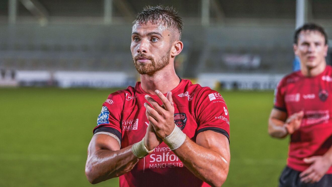 Jack Walker applauds the Salford Red Devils supporters following a game in 2025