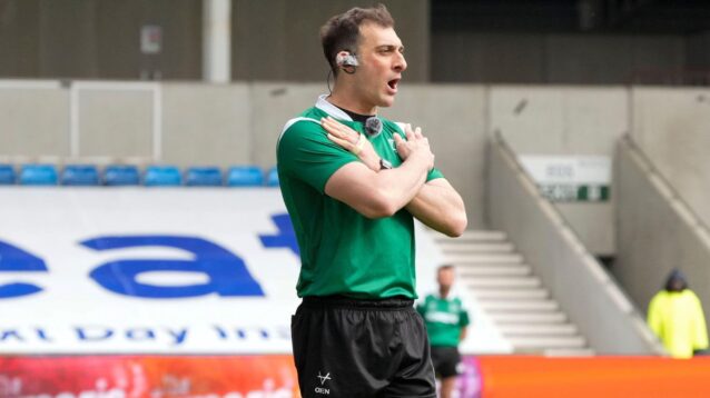 James Vella signals 'no try' as he sends a decision up to the video referee during a Super League game