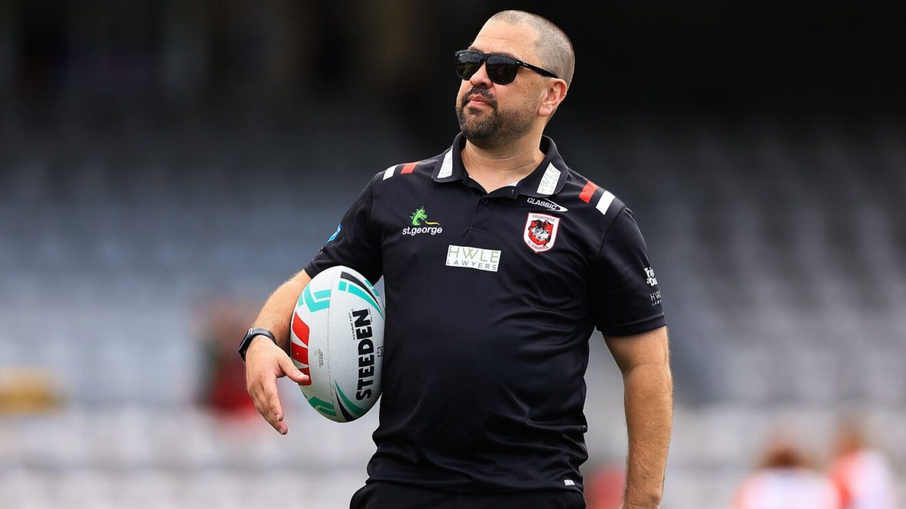 Jamie Soward pictured ahead of a game during his time as the head coach of St George Illawarra Dragons' NRWL side, wearing sunglasses and holding a ball