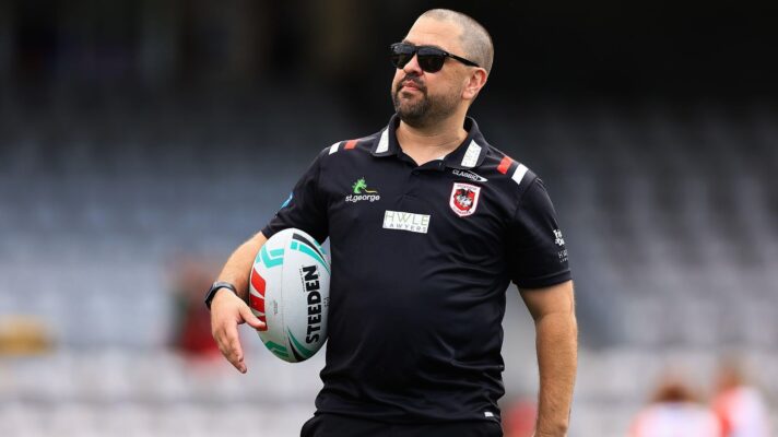 Jamie Soward pictured ahead of a game during his time as the head coach of St George Illawarra Dragons' NRWL side, wearing sunglasses and holding a ball