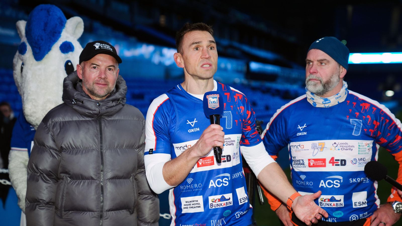 Kevin Sinfield speaks to the crowd at Portman Road alongside former Ipswich Town striker Marcus Stewart, who is battling against MND, after completing day one of his '7 in 7: Together' challenge in 2025