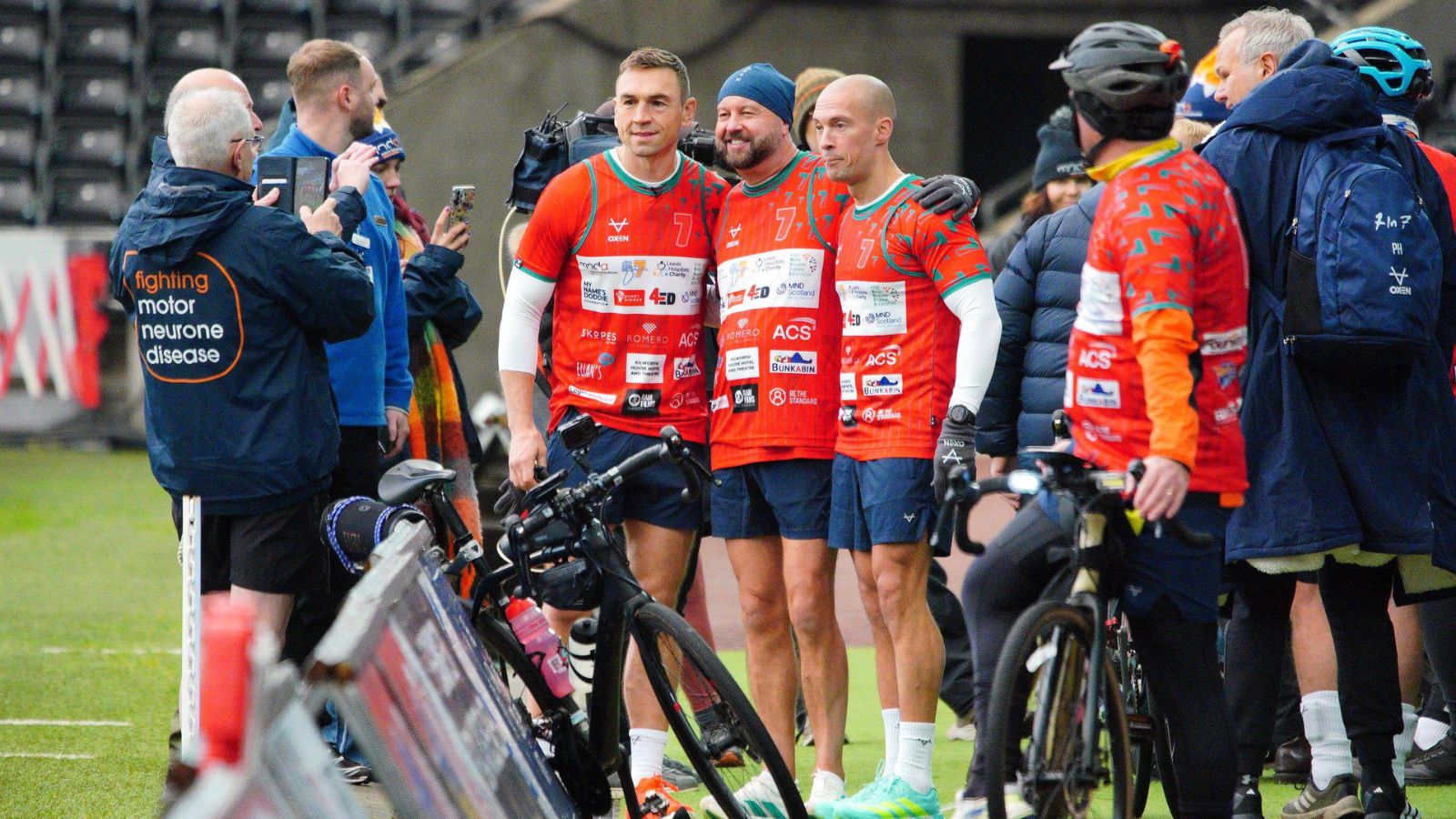 Kevin Sinfield and his team pose for a picture at the Swansea.com Stadium after finishing their third ultra-marathon during the '7 in 7: Together' challenge in 2025