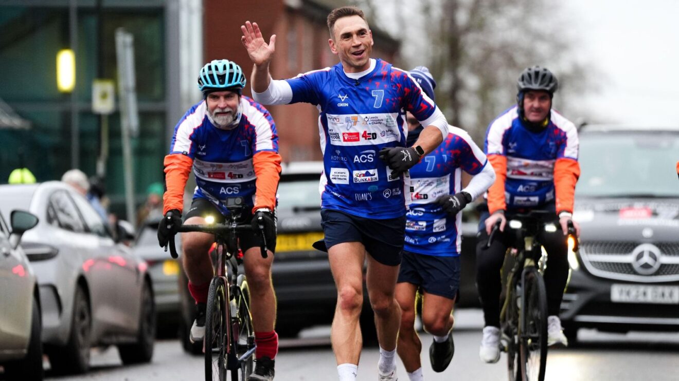 Kevin Sinfield waves to the crowds as he runs from Bury St Edmunds to Ipswich during day one of his '7 in 7: Together' challenge in 2025