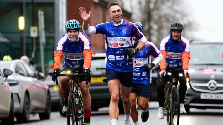 Kevin Sinfield waves to the crowds as he runs from Bury St Edmunds to Ipswich during day one of his '7 in 7: Together' challenge in 2025