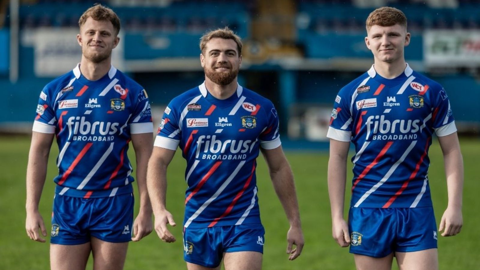 Three Workington Town players model their home kit for 2026 at Derwent Park - Image credit: Workington Town