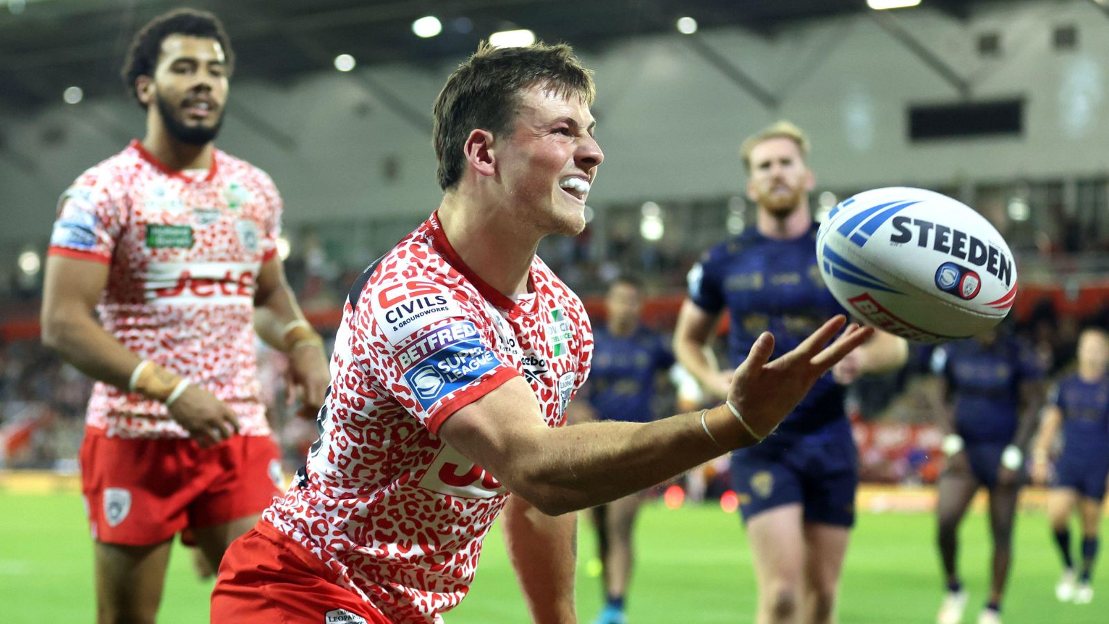 AJ Towse celebrates a try for Leigh Leopards against Salford Red Devils in 2025