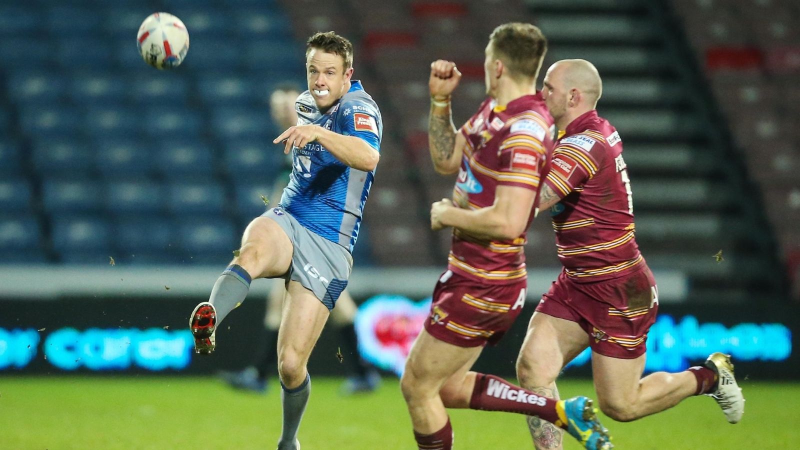 Sam Williams in action for Wakefield Trinity in 2017, pictured as he kicks the ball downfield during a Super League game against Huddersfield Giants