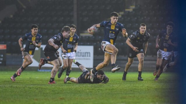 Oscar Brown in action for Leeds Rhinos during Brad Singleton's testimonial in January 2026, running through numerous Castleford Tigers defenders