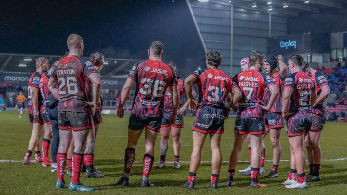 Salford RLFC players gather behind the sticks having conceded a try during a game in 2026