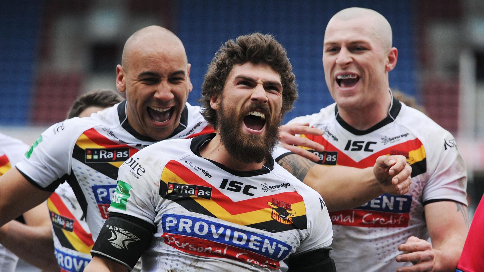 Jarrod Sammut celebrates a try for Bradford Bulls alongside two team-mates in 2013