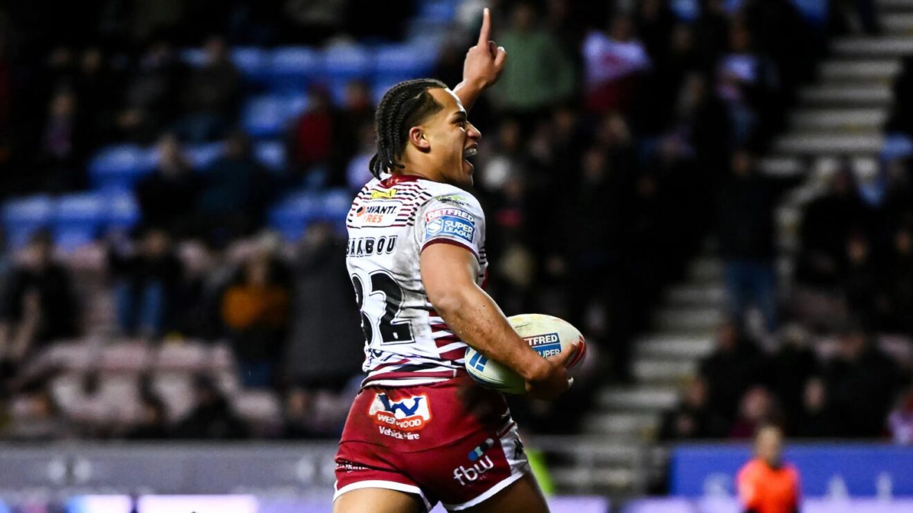 Dayon Sambou all smiles as he races in to score a try on debut for Wigan Warriors in 2026 - Image credit: Wigan Warriors