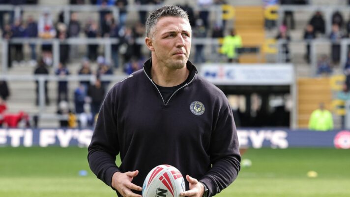 Warrington Wolves head coach Sam Burgess pictured ahead of a game in 2026 with a ball in hand