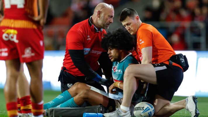 Lewis Murphy is helped by St Helens' medical team after dislocating his elbow in a Challenge Cup tie against Catalans Dragons in 2026