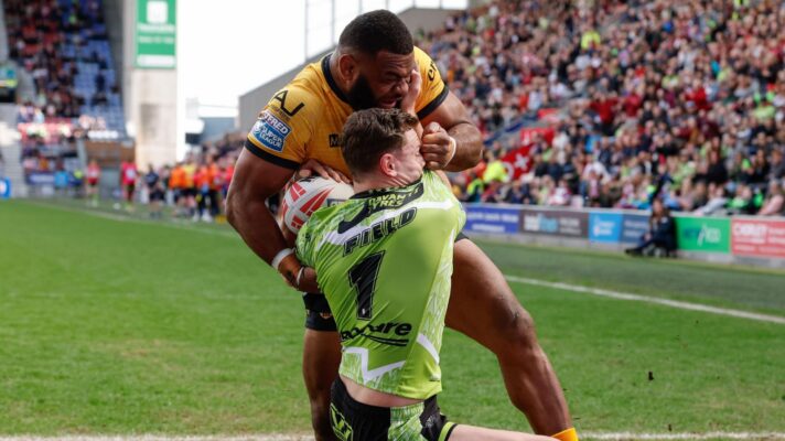 Castleford Tigers' Mikaele Ravalawa tackles Wigan Warriors' Jai Field during a Super League game in 2026