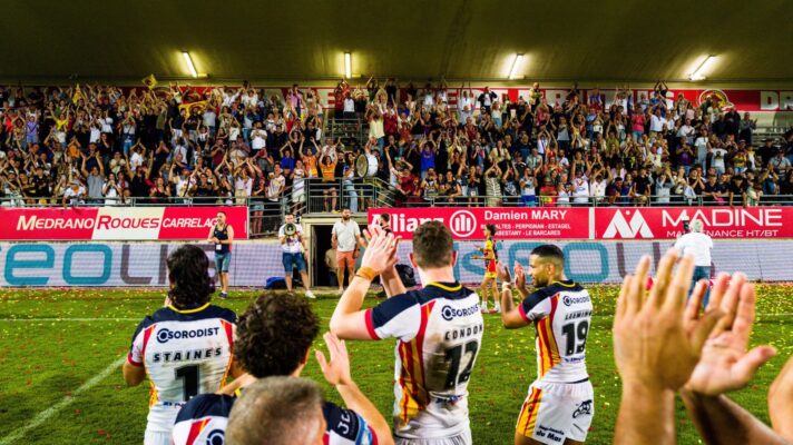 Catalans Dragons players applaud supporters at the Stade Gilbert Brutus following victory over Warrington Wolves in Round 8 of the 2026 Super League season