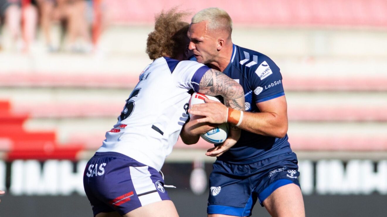 Ellis Gillam in action for Toulouse Olympique in 2026, being tackled by Wakefield Trinity's Caius Faatili