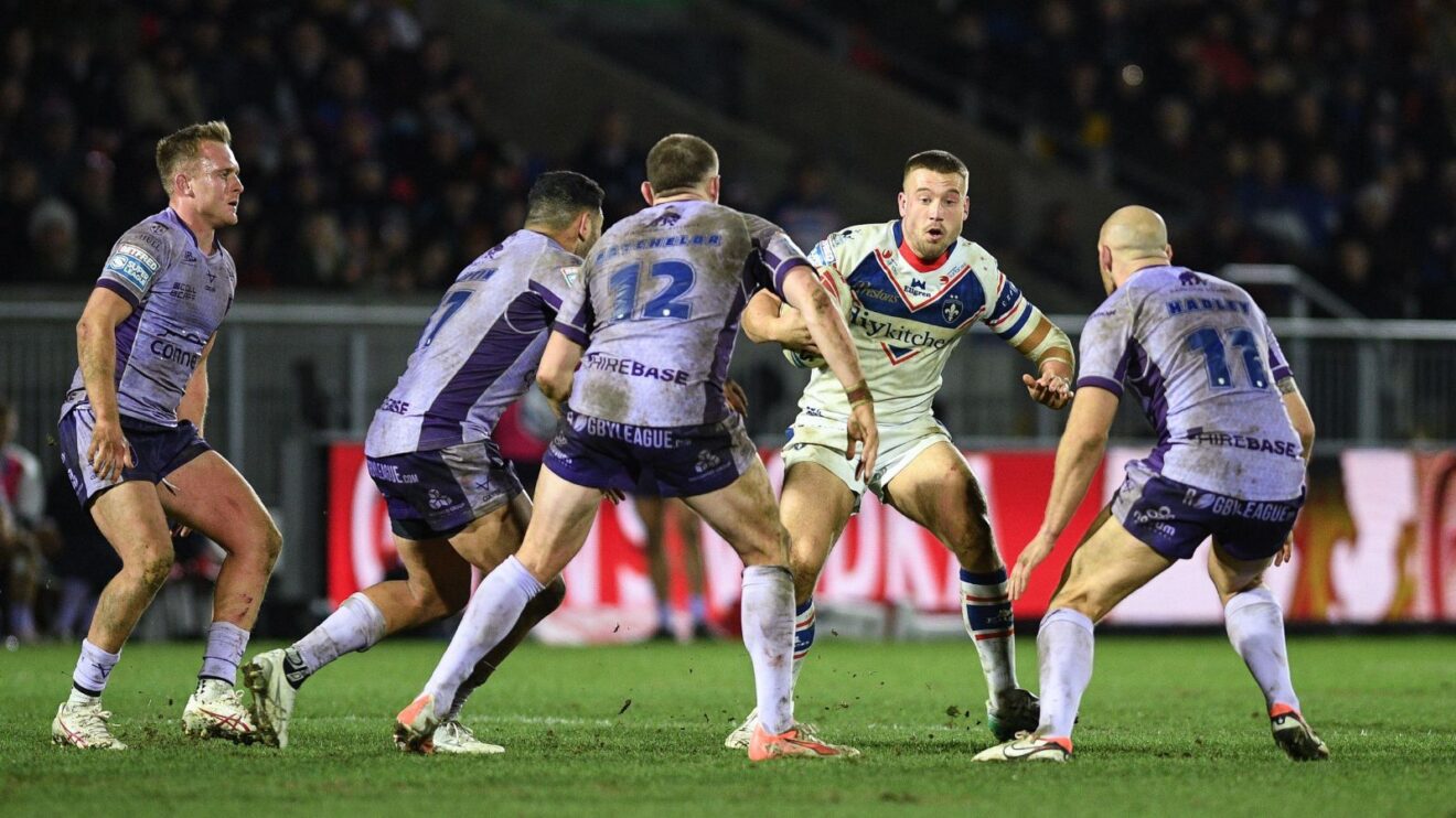 Thomas Doyle in action for Wakefield Trinity in 2025, being closed down by four Hull KR defenders