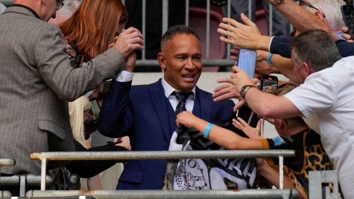 Adrian Lam is swarmed by Leigh supporters at Wembley as he goes to collect his medal following the Leopards' Challenge Cup final triumph over Hull KR in 2023
