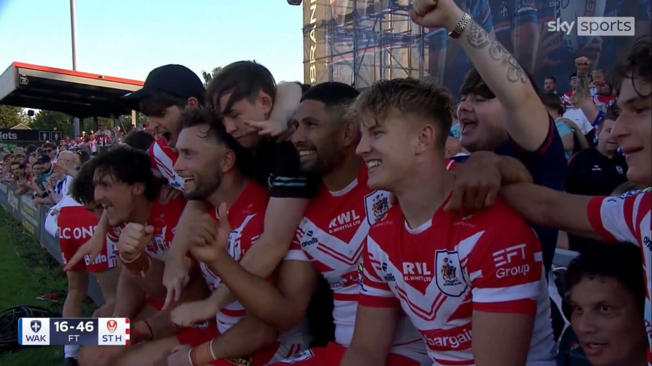 St Helens celebrate their victory away at Wakefield Trinity in August 2026 with a picture in front of their supporters