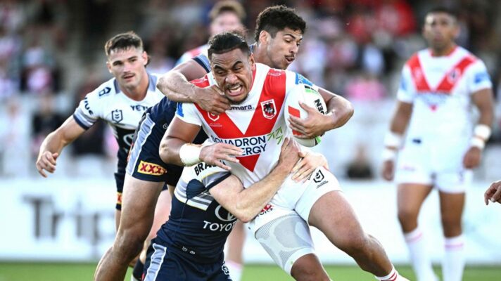 Christian Tuipulotu in action for St George Illawarra Dragons, being tackled by two North Queensland Cowboys defenders