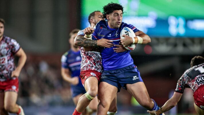 Emre Guler in action for Wakefield Trinity in 2026, being tackled by Leigh Leopards' Liam Horne
