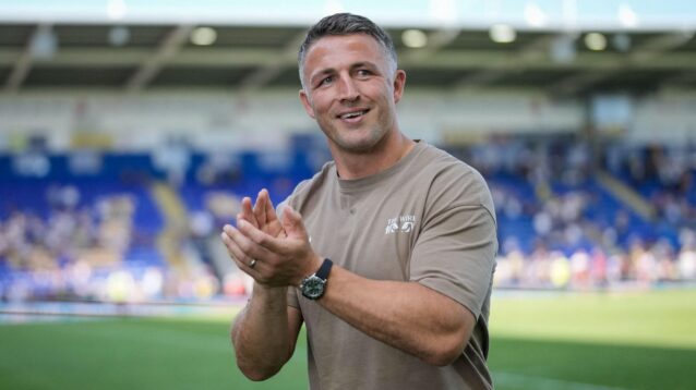 Warrington Wolves head coach Sam Burgess applauds supporters following a game in 2026