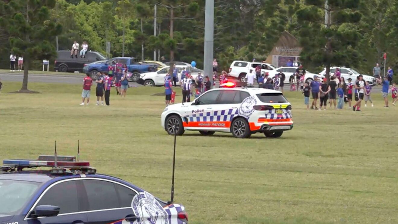 Emergency workers and pedestrians gather near the site where a car drove into a large crowd during Newcastle Knights' send-off for the 2026 NRL Grand Final